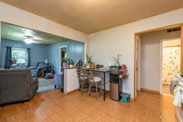a view of a dining hall with furniture and a window