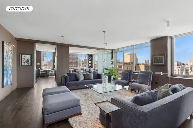 a living room with furniture and wooden floor