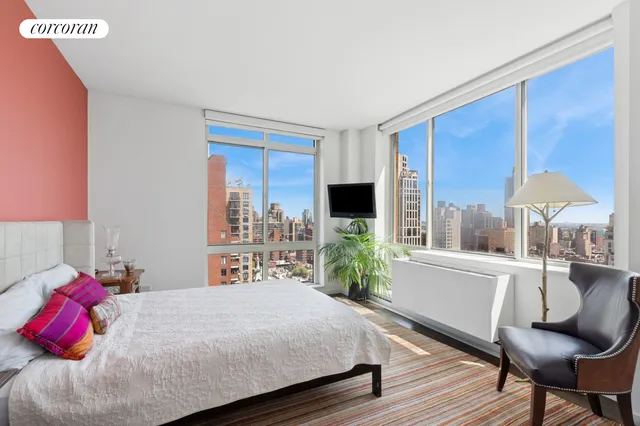 a bathroom with a double vanity sink a mirror and a bathtub