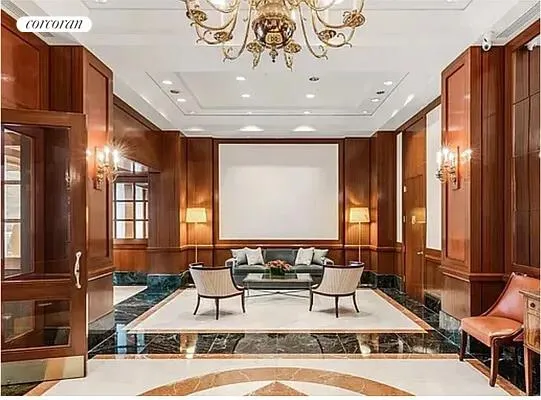 an empty room with wooden floor mirror and windows