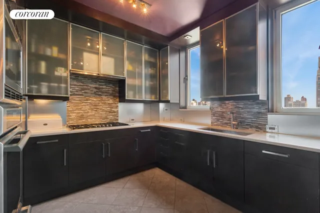 a living room with stainless steel appliances furniture a fireplace and a book shelf