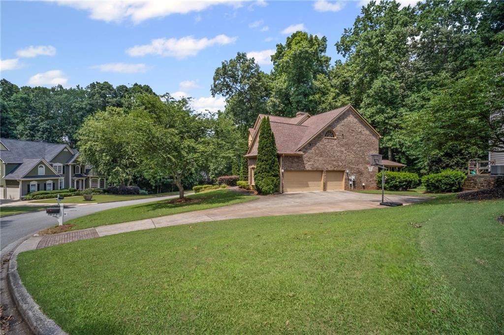 403 Glenhurst Trace Canton, GA 30115 - Photo 13 of 73 a view of a house with a big yard potted plants and large tree