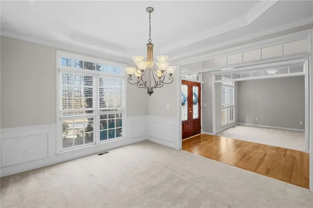 a view of a hallway with bathroom and wooden floor