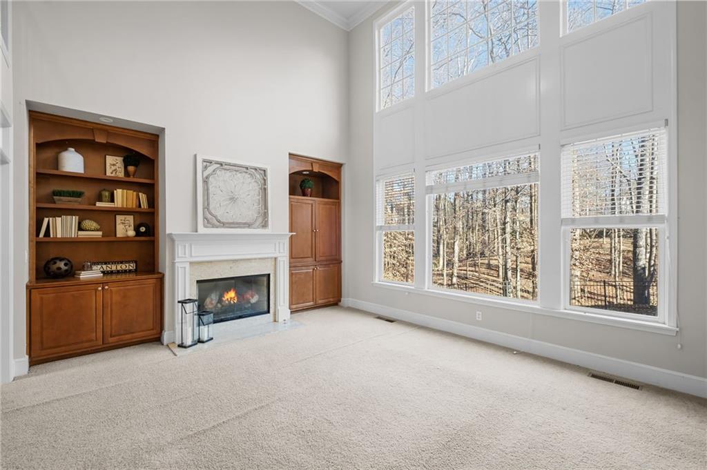 403 Glenhurst Trace Canton, GA 30115 - Photo 21 of 73 a view of an empty room with a fireplace and a window