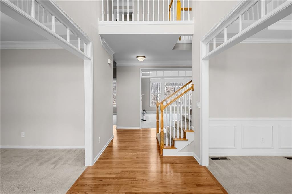 403 Glenhurst Trace Canton, GA 30115 - Photo 24 of 73 a view of a hallway with wooden floor and staircase