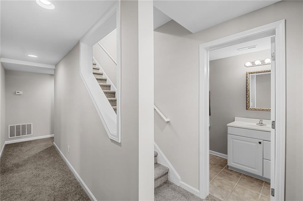 403 Glenhurst Trace Canton, GA 30115 - Photo 45 of 73 a view of a hallway with bathroom and wooden floor