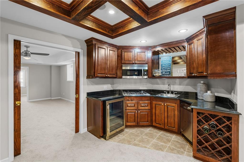 403 Glenhurst Trace Canton, GA 30115 - Photo 52 of 73 a kitchen with stainless steel appliances granite countertop a sink and cabinets