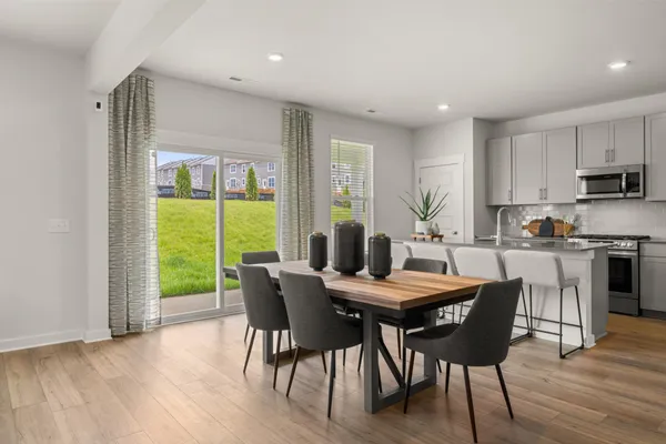 a view of a dining room with furniture window and wooden floor