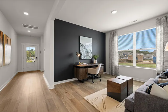 a living room with furniture window and wooden floor