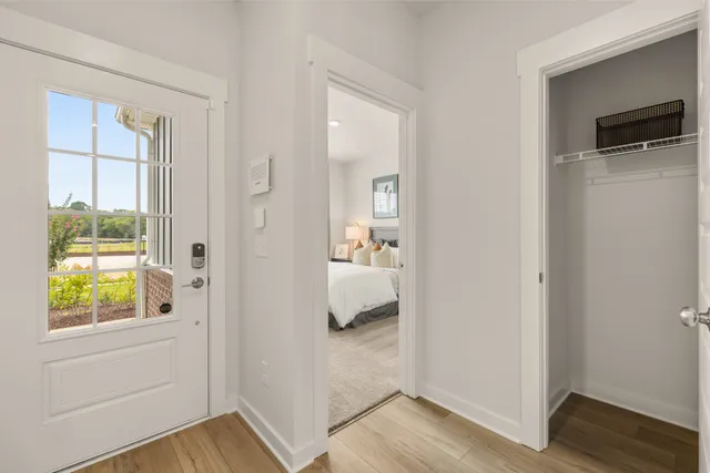 a bedroom with a large bed and a potted plant
