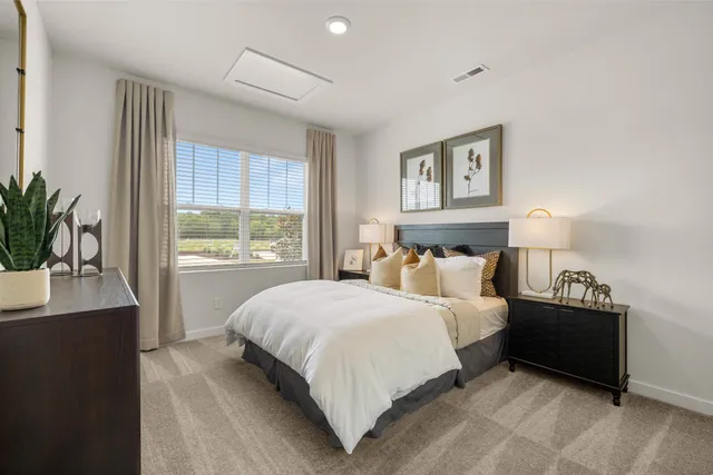 a bedroom with a bed and a night stand