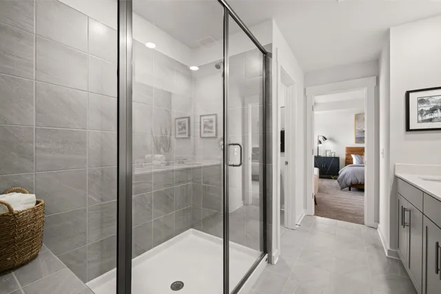 a bathroom with a double vanity sink mirror and shower