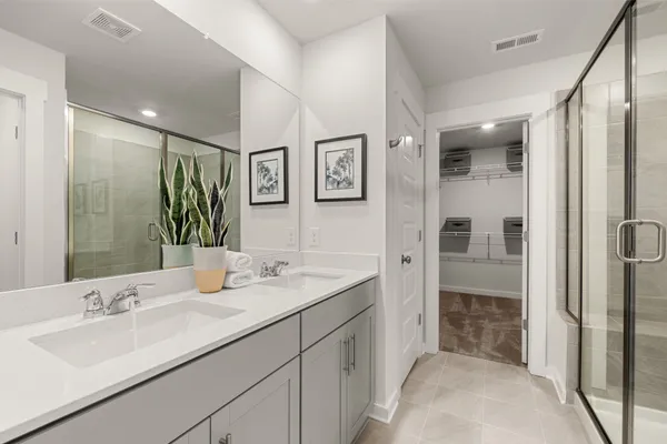 a en suite bathroom with double sink and a mirror