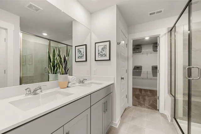 a en suite bathroom with double sink and a mirror