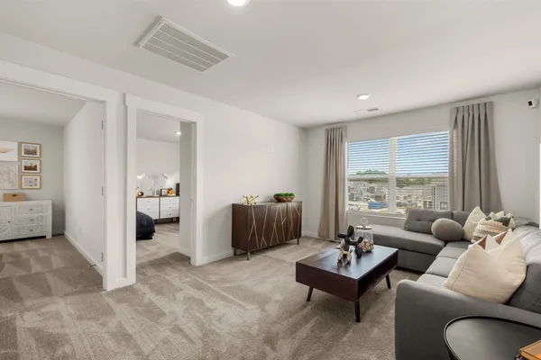 a bedroom with a bed and windows