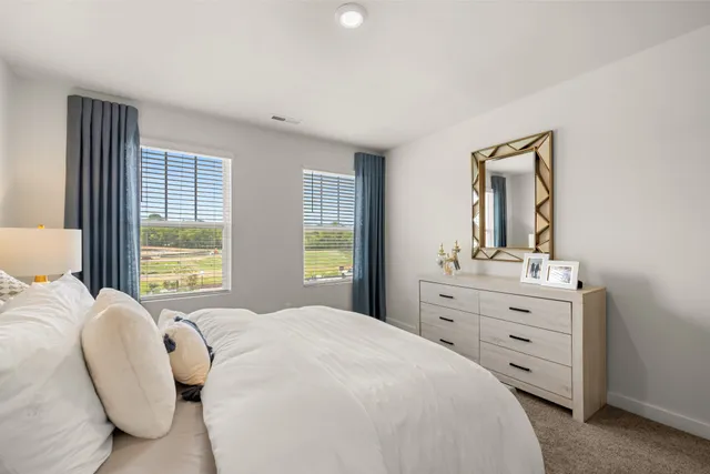 a bedroom with a bed and window