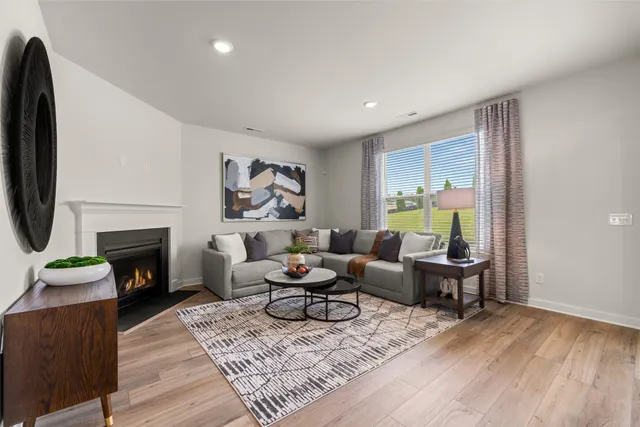 a living room with furniture a fireplace and a wooden floor