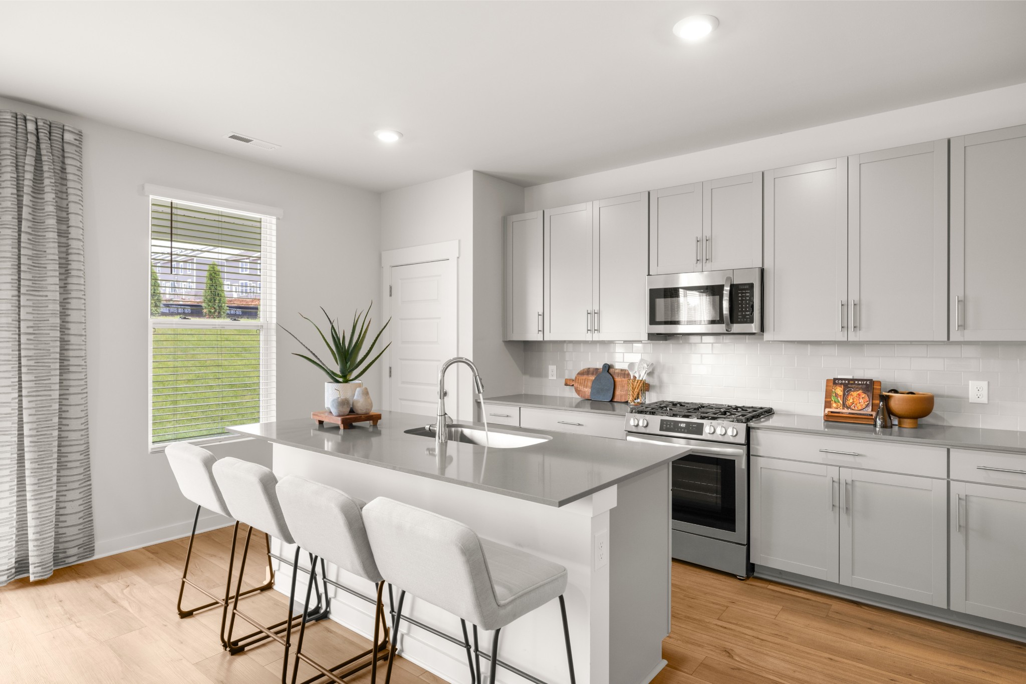 2412 Williams Rdg Drive Columbia, TN 38401 - Photo 10 of 54 a kitchen with stainless steel appliances granite countertop a stove a sink dishwasher a microwave oven and a dining table with wooden floor