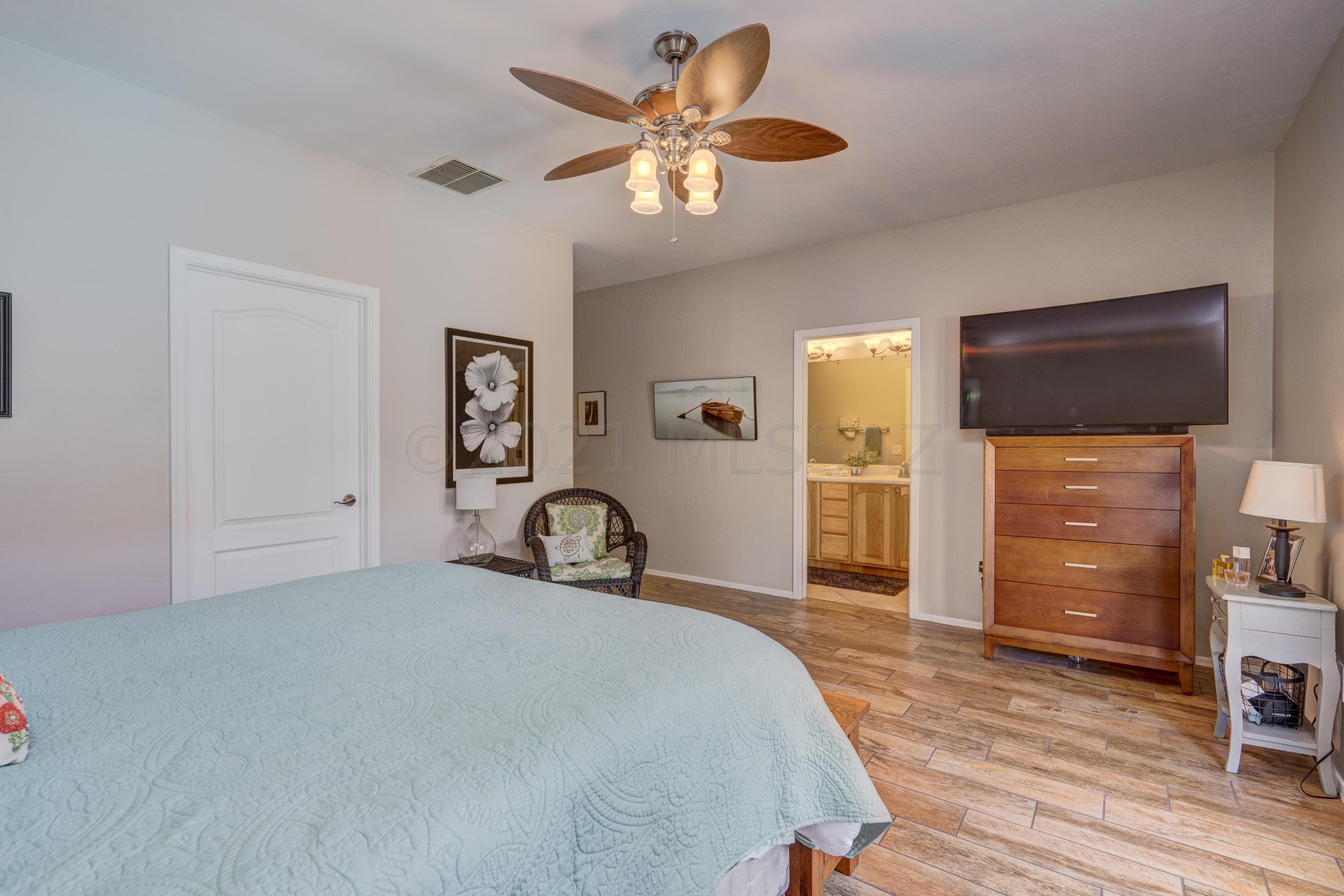 3639 East Northern Dancer Road Tucson, AZ 85739 - Photo 25 of 48 a bedroom with a bed and a television