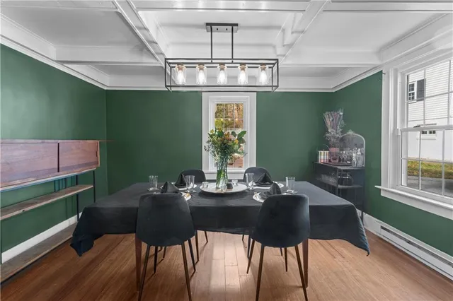 a view of a dining room with furniture window and wooden floor