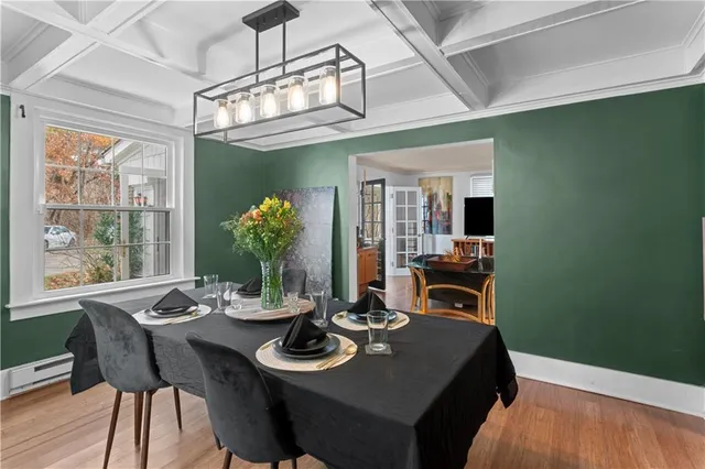 a view of a dining room with furniture wooden floor and chandelier
