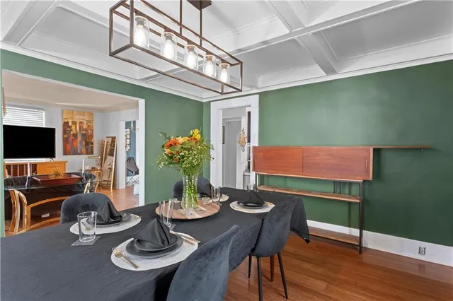 a view of a dining room with furniture and wooden floor