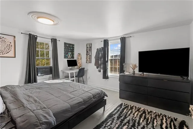 a bedroom with a bed and a flat screen tv