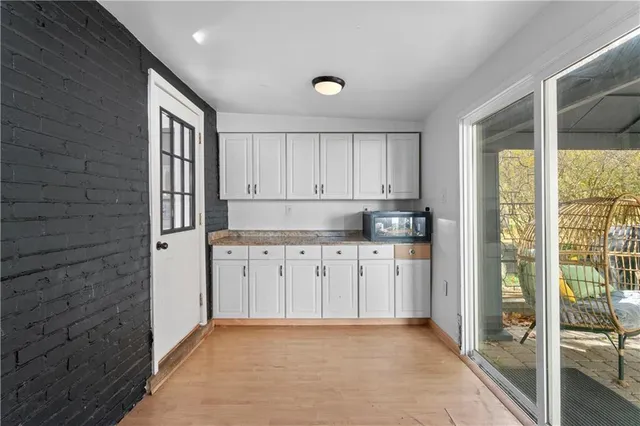 a kitchen with granite countertop a refrigerator sink and cabinets
