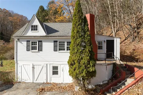 a view of house with a yard and fountain