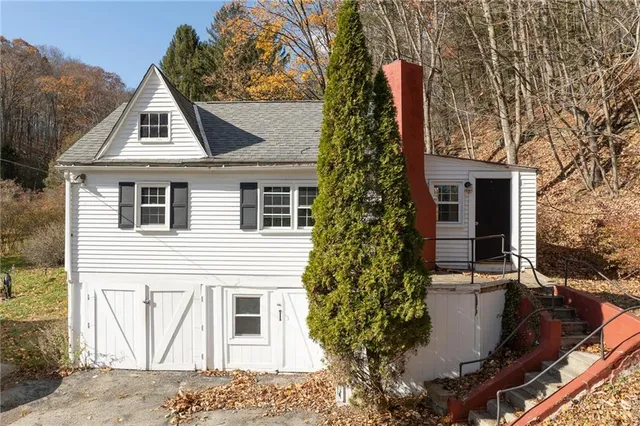 a view of house with a yard and fountain