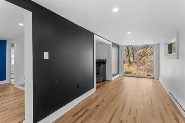 wooden floor in an empty room with a window