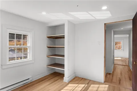 a view of a room with wooden floor and windows