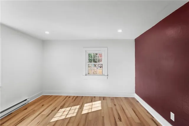 a view of an empty room and wooden floor
