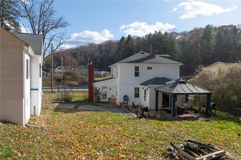 a view of a house with backyard porch and sitting area
