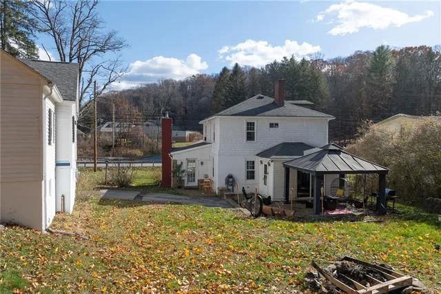 a view of a house with backyard porch and sitting area