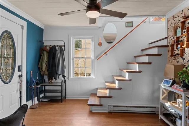 a view of entryway and hall with wooden floor