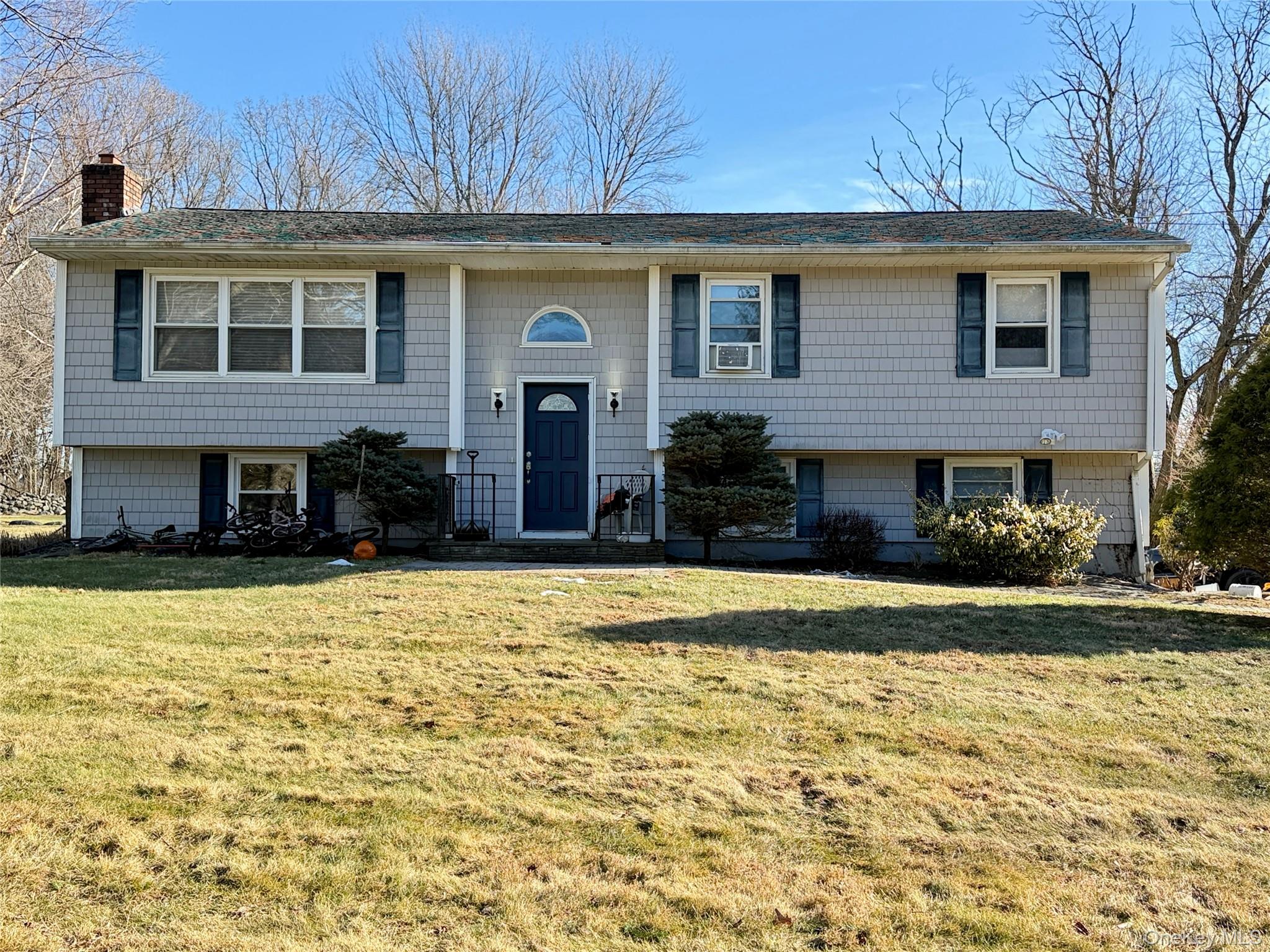 110 Wayacross Road Mahopac, NY 10541 - Photo 1 of 18 Bi-level home featuring a front lawn and a chimney