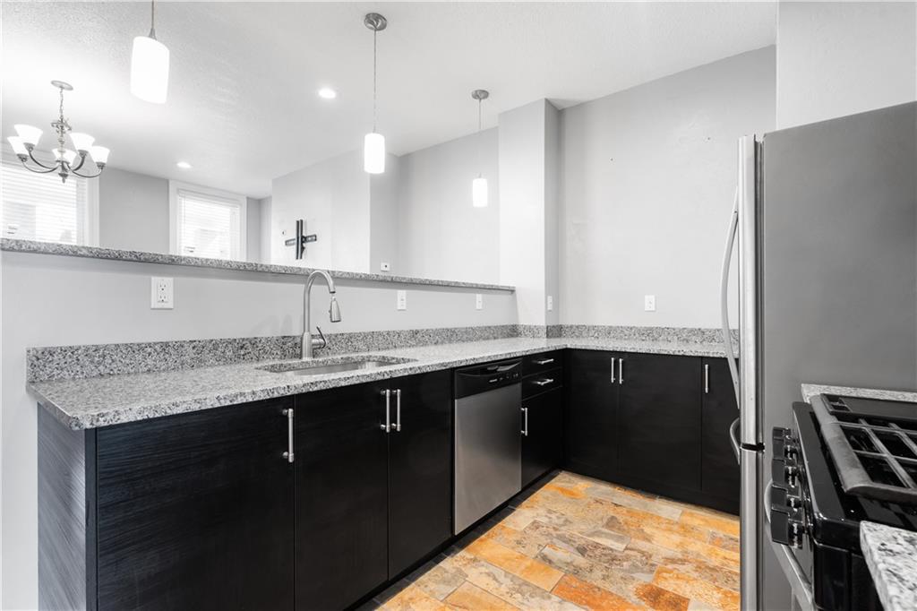 2918 Spring Street Pittsburgh, PA 15210 - Photo 8 of 25 a kitchen with a sink appliances and a counter top space