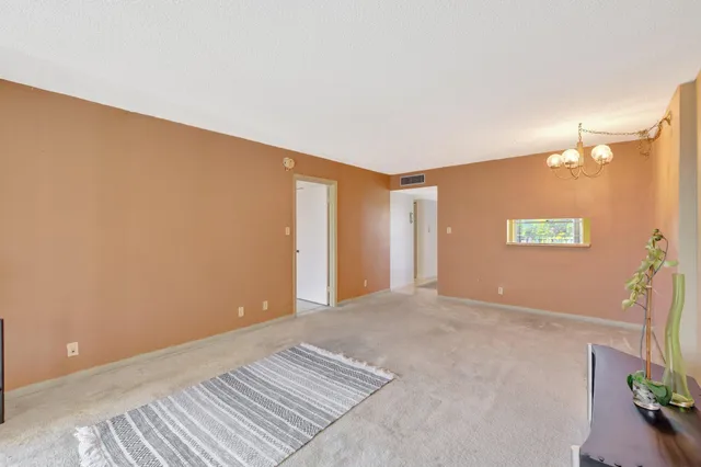a view of a kitchen area with furniture and wooden floor