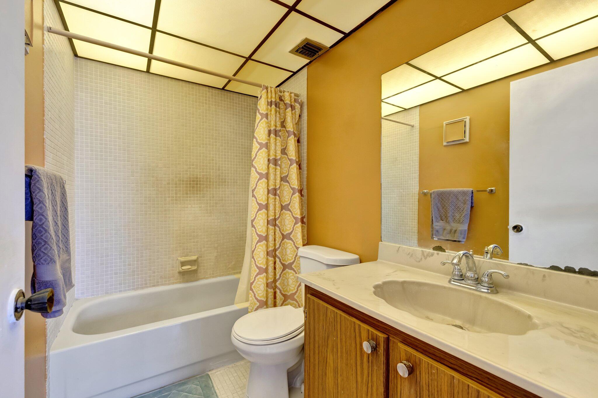 3301 Northwest 47th Terrace, Unit 410 Lauderdale Lakes, FL 33319 - Photo 24 of 58 a bathroom with a granite countertop sink a toilet and bathtub