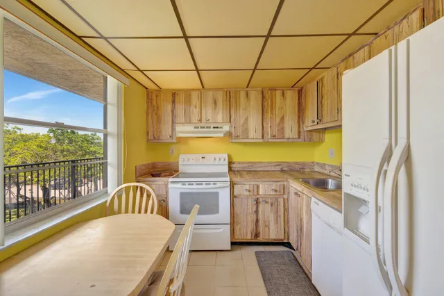 a bathroom with a granite countertop sink and shower