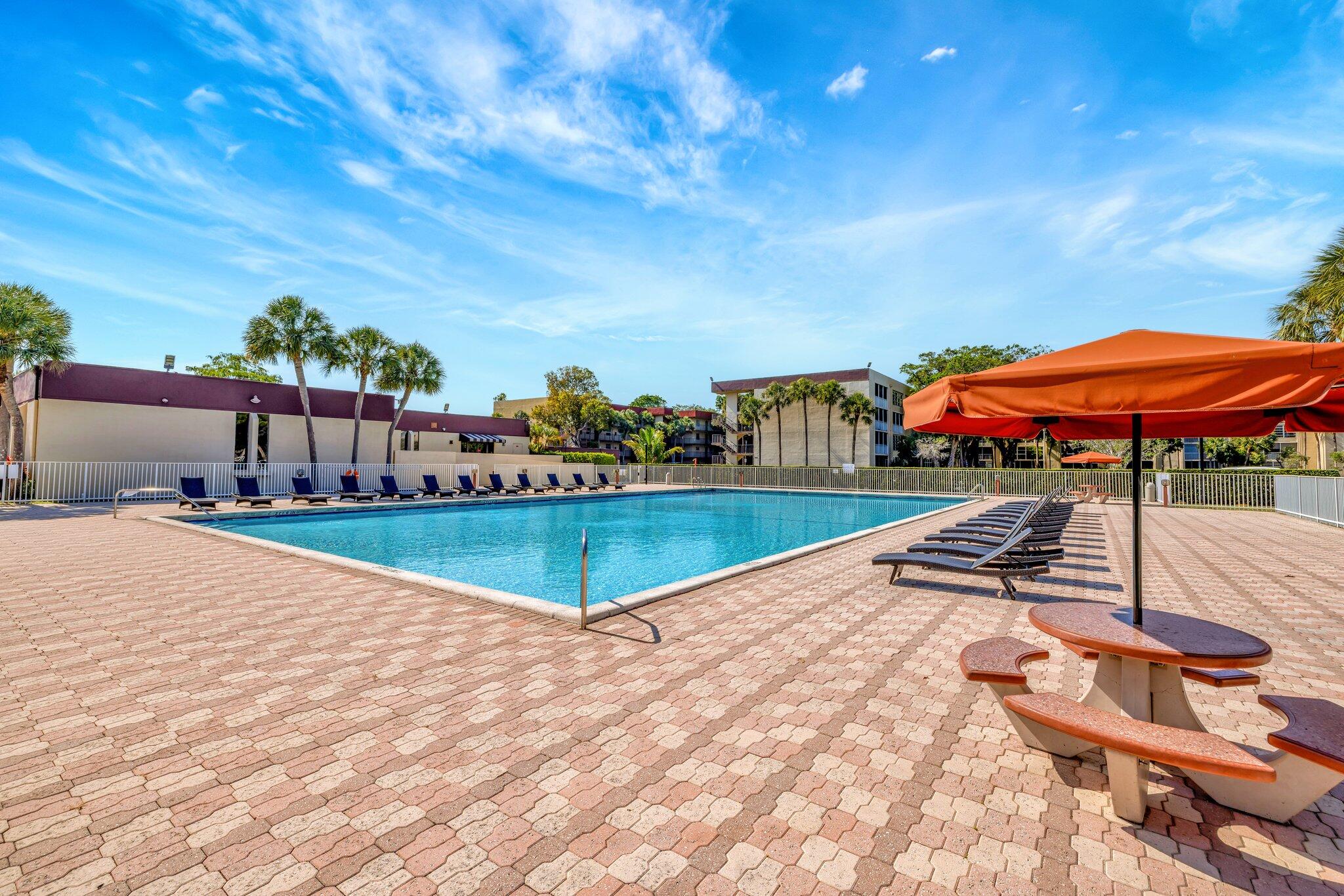 3301 Northwest 47th Terrace, Unit 410 Lauderdale Lakes, FL 33319 - Photo 43 of 58 a view of a swimming pool with a patio