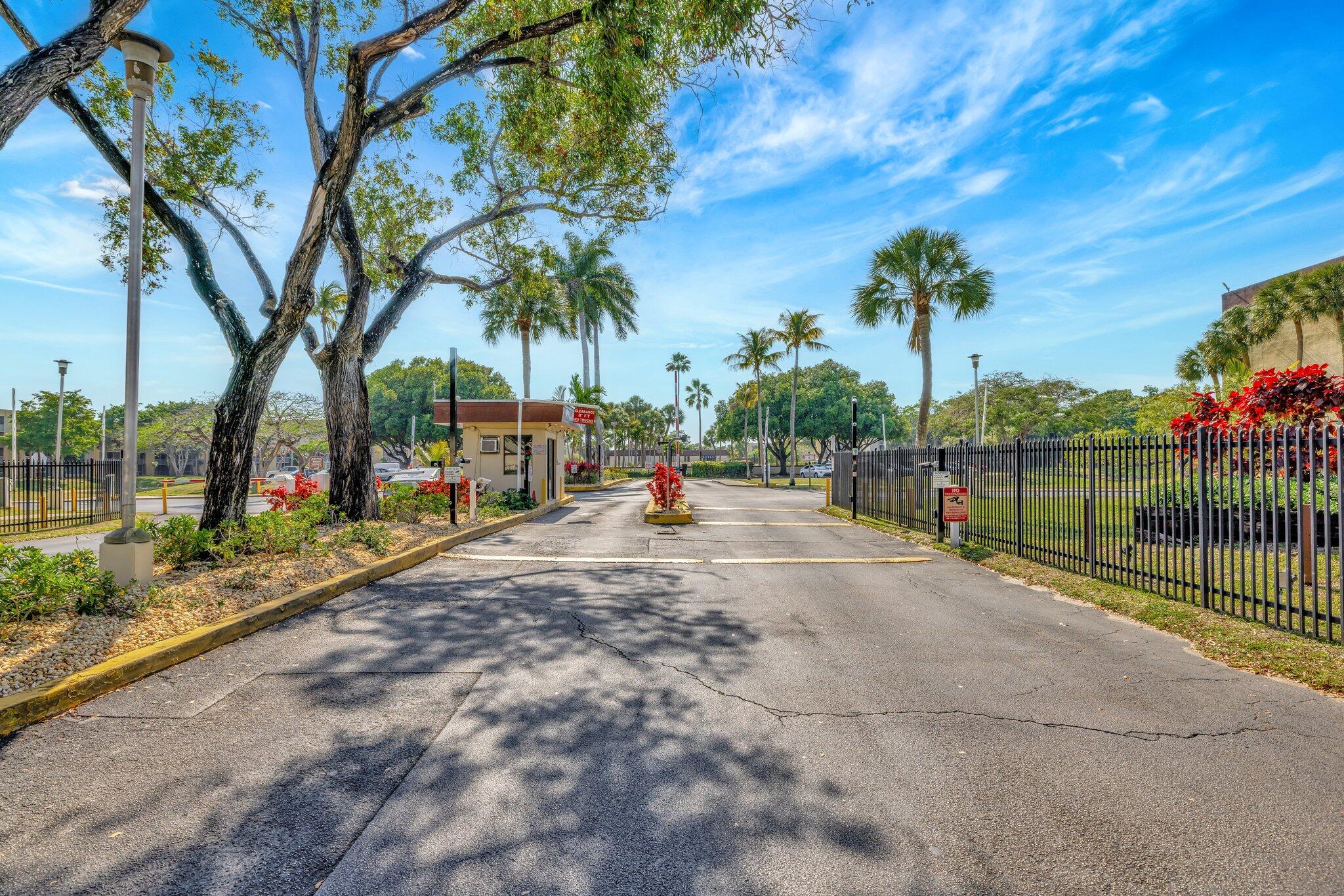 3301 Northwest 47th Terrace, Unit 410 Lauderdale Lakes, FL 33319 - Photo 47 of 58 a view of outdoor space with swimming pool and trees in the background