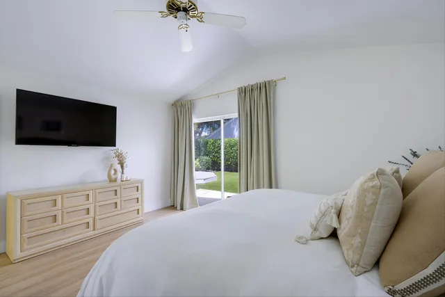 a bathroom with a sink vanity granite tub and a mirror