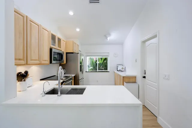 a kitchen with a sink stove and microwave