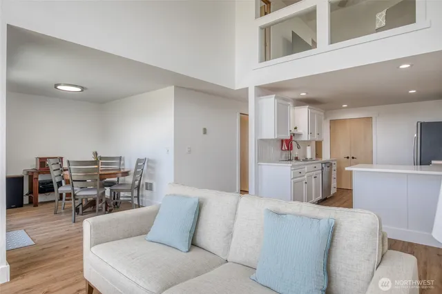 a living room with furniture and large windows