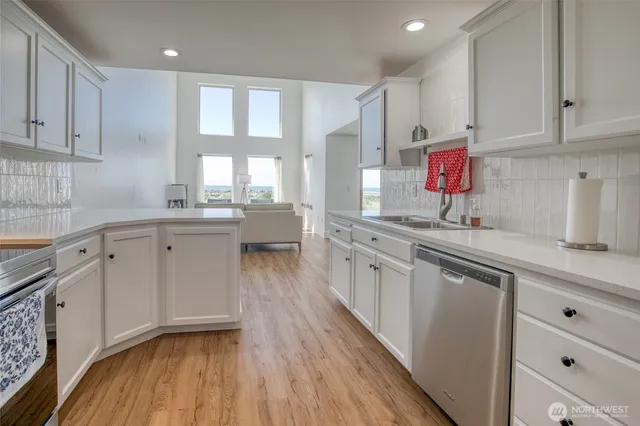a kitchen with a refrigerator sink and cabinets