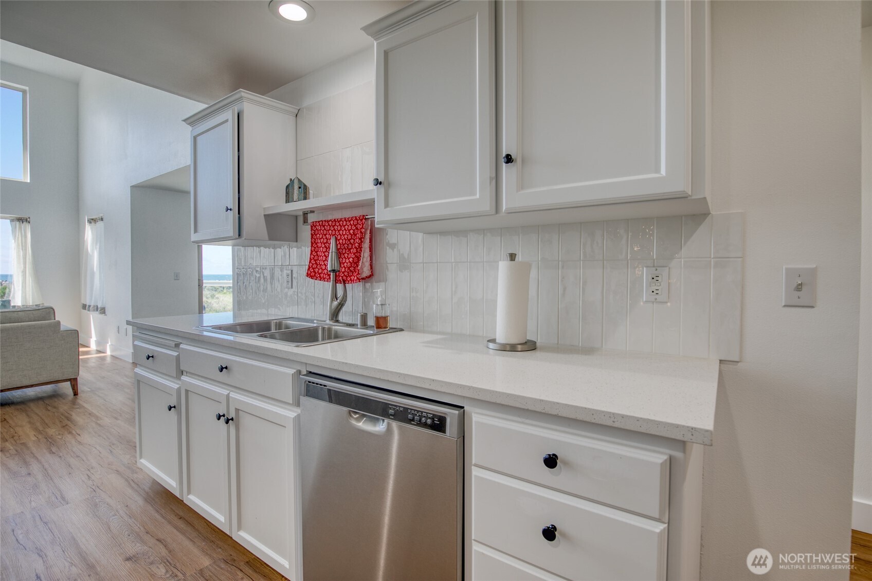 1472 Storm King Way Southwest, Unit A Ocean Shores, WA 98569 - Photo 19 of 39 a kitchen with white cabinets and sink