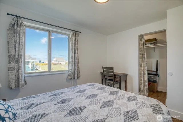 a spacious bathroom with a toilet sink and mirror