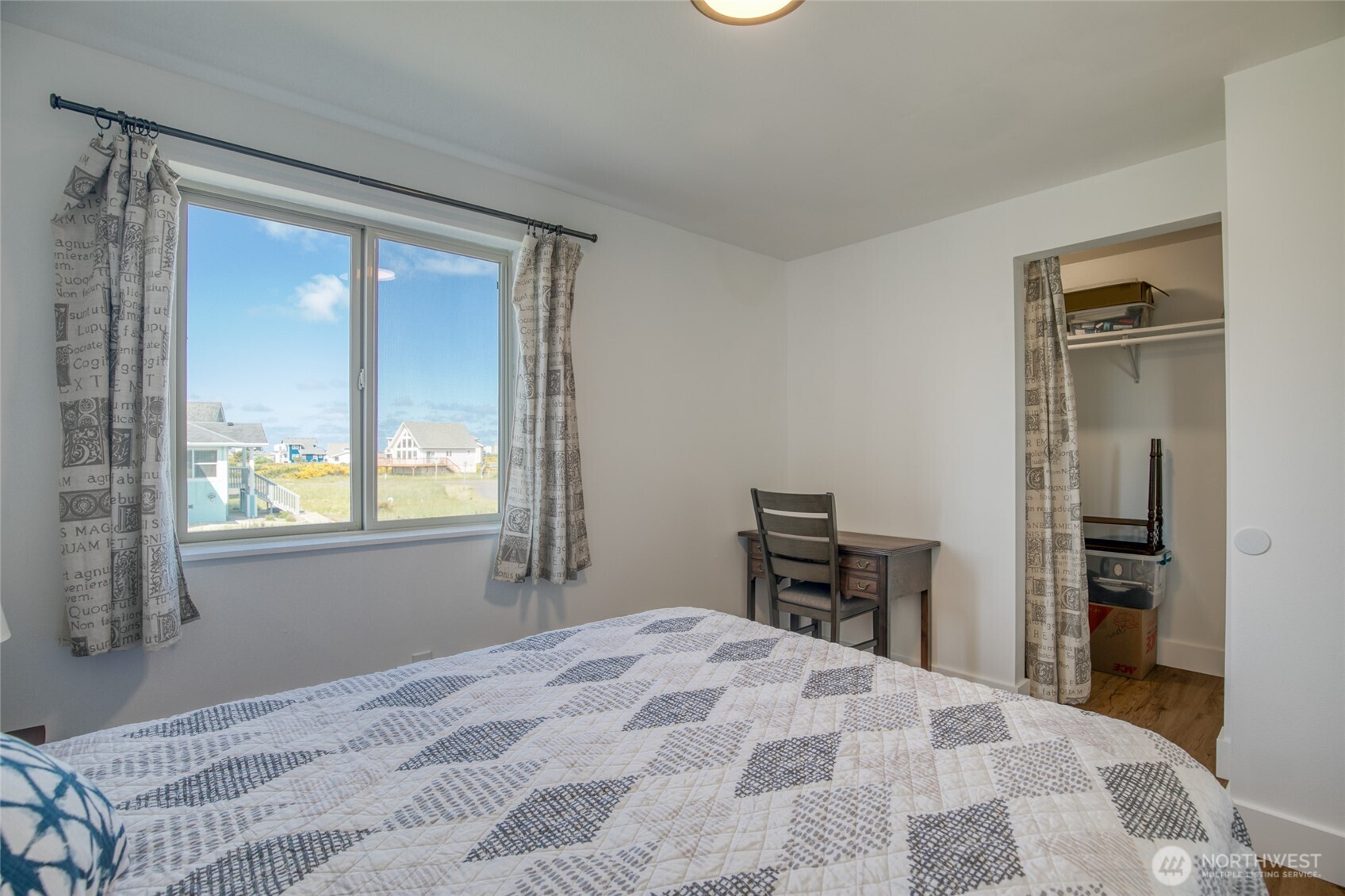 1472 Storm King Way Southwest, Unit A Ocean Shores, WA 98569 - Photo 21 of 39 a bedroom with a bed and a dresser next to a window